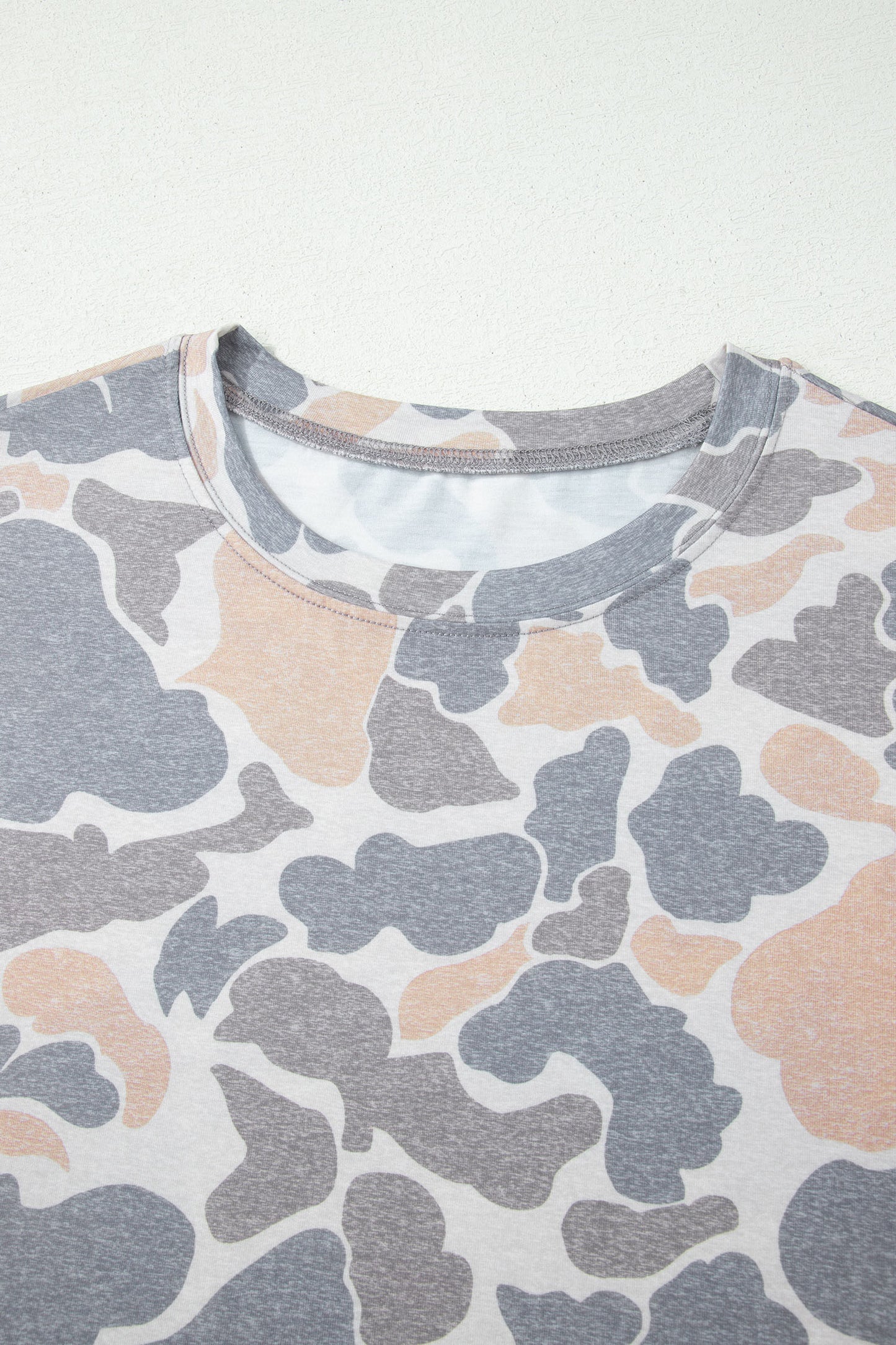 Camouflage-patterned shirt on a white background