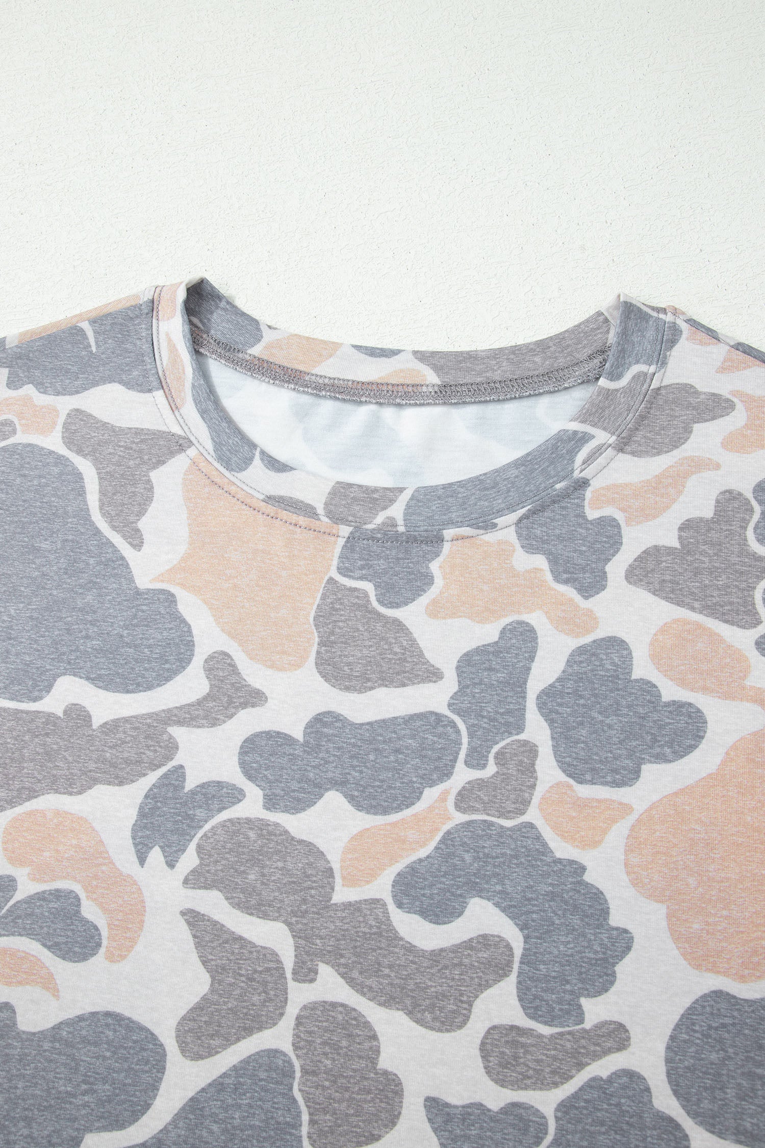 Camouflage-patterned shirt on a white background