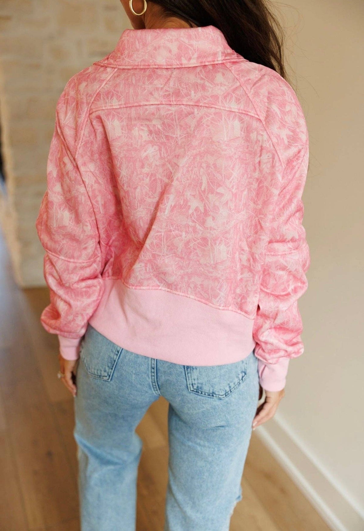 Back view of Hadley pink camouflage quarter-zip pullover