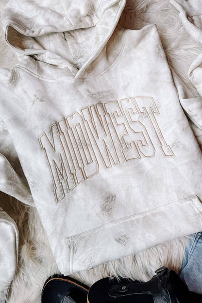 Close-up of tonal MIDWEST embroidery on white birch camouflage hoodie