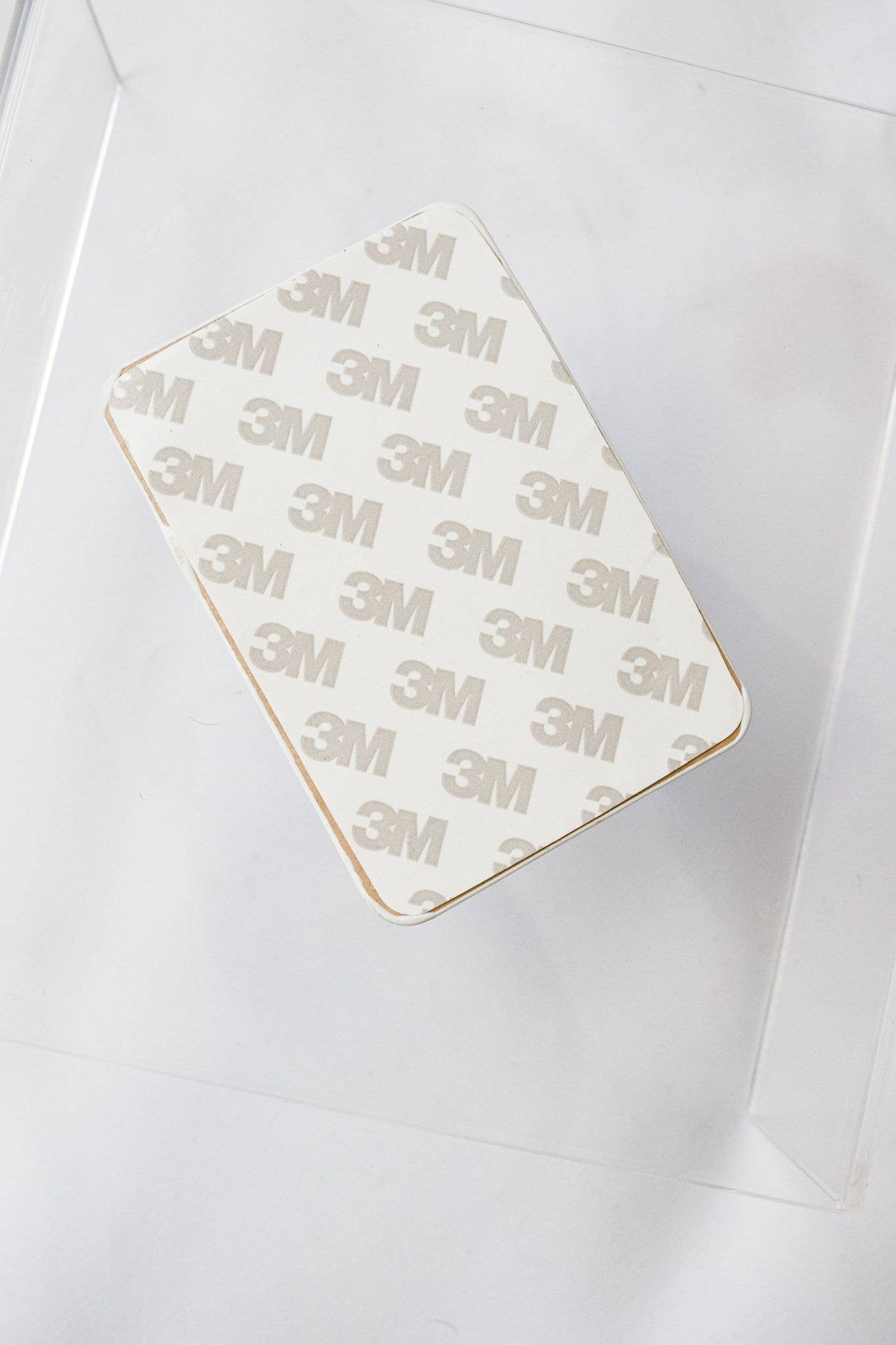 Adhesive patch with '3M' branding on a white background