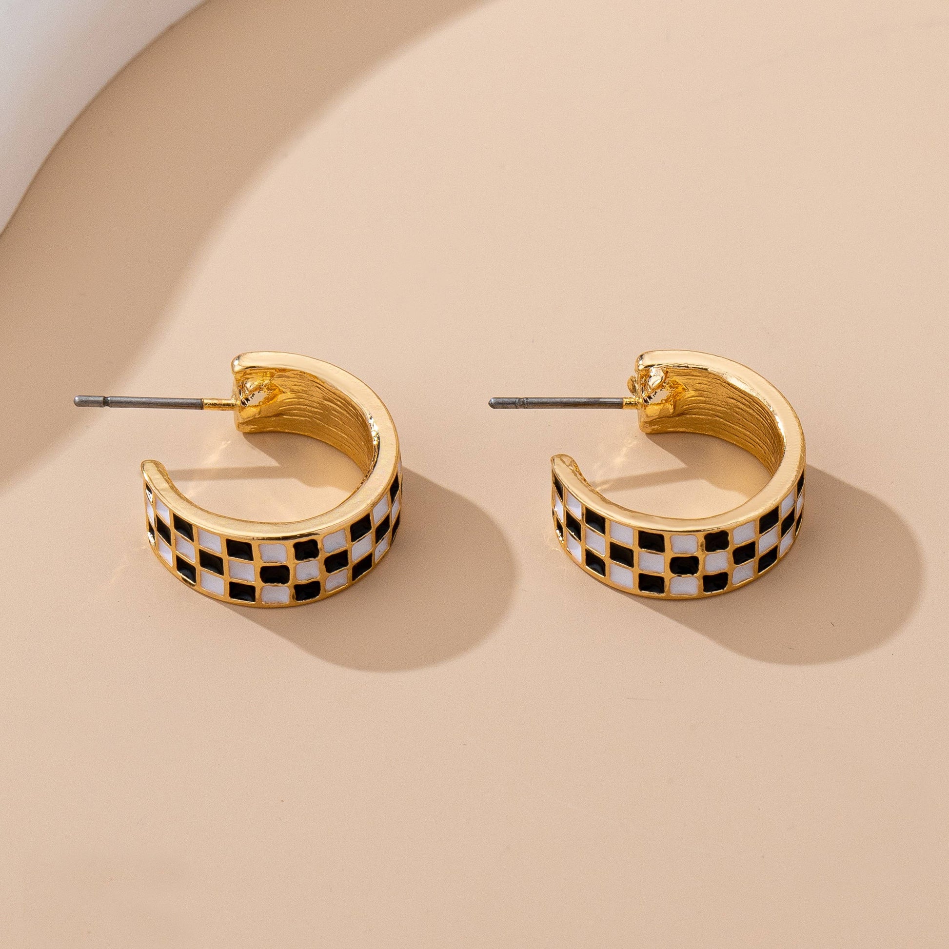 Sloane checkered huggie hoop earrings showing the gold-tone backs and titanium posts

