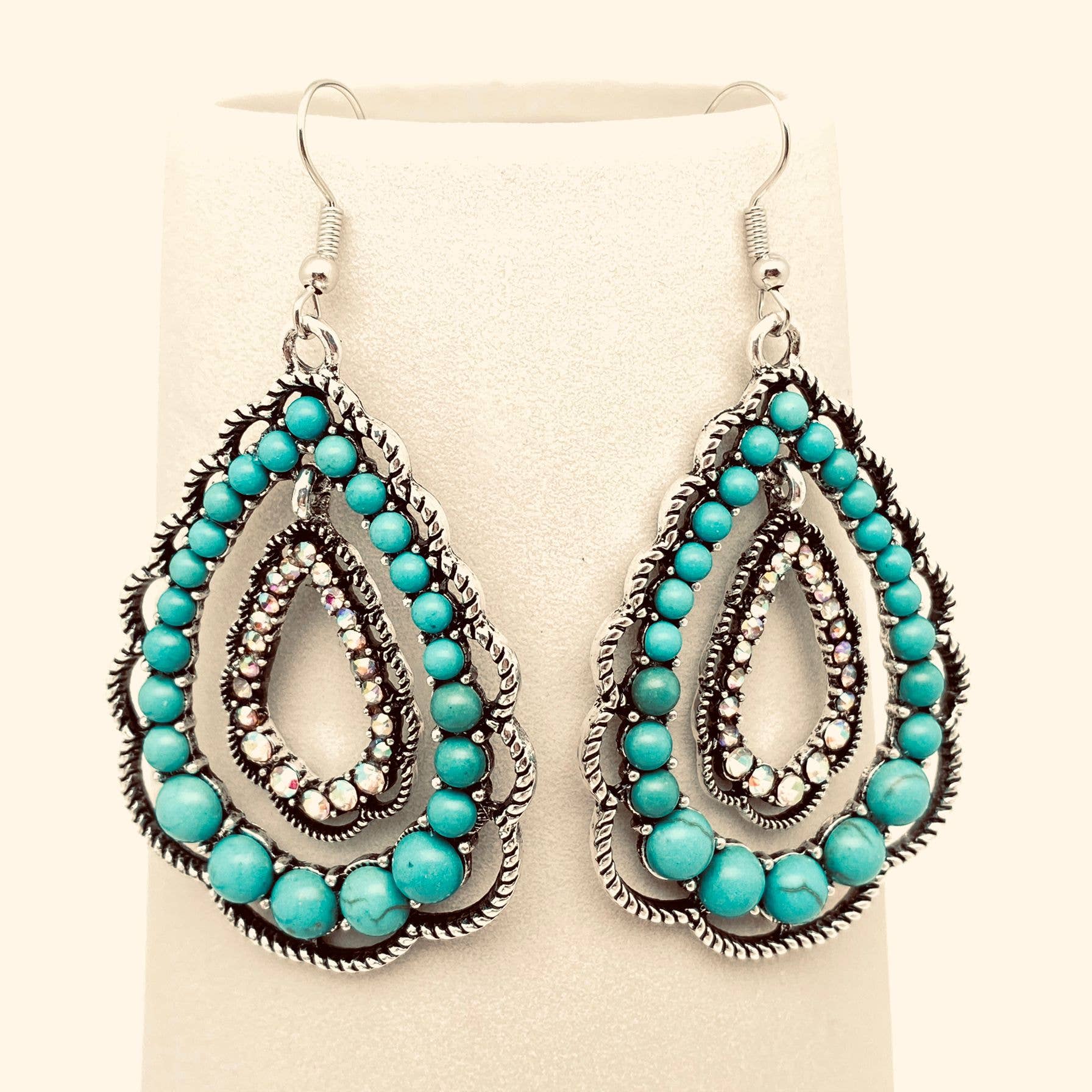 Turquoise beaded earrings on a beige background
