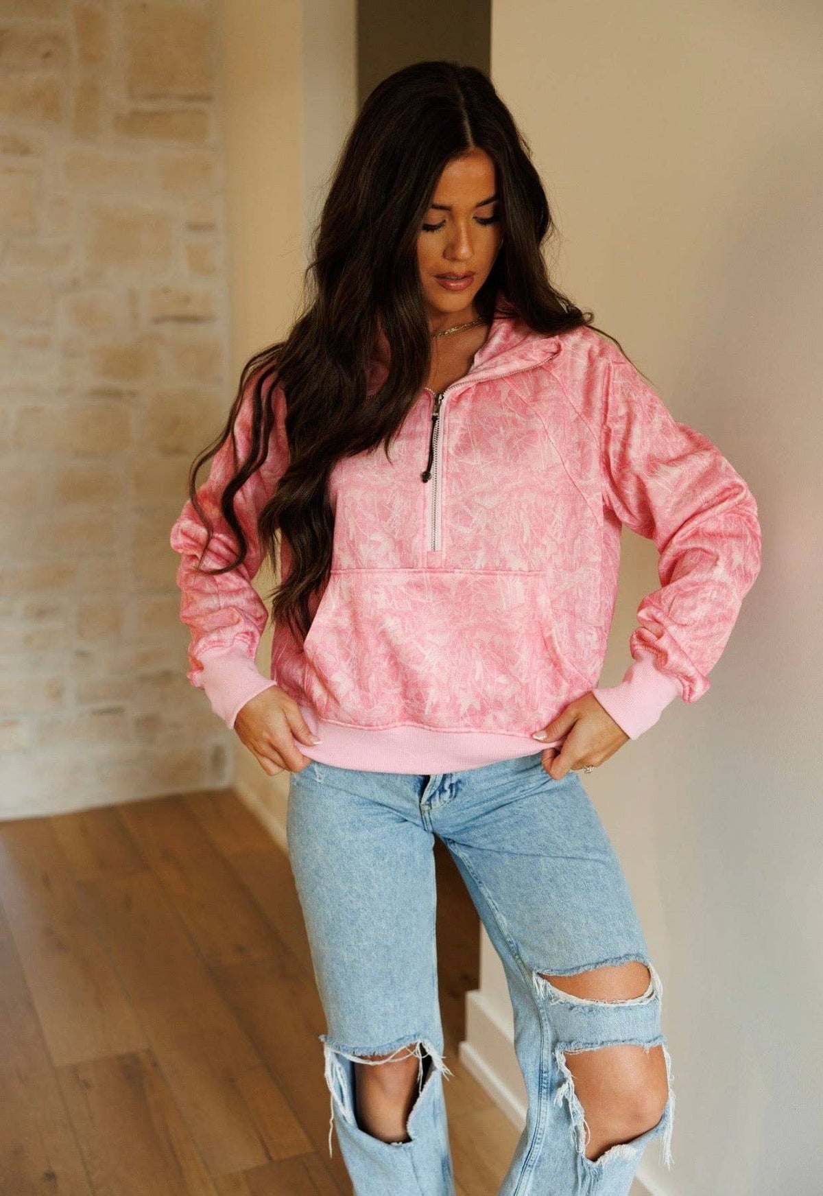 Women's pink camo pullover with relaxed fit and quarter-zip neckline